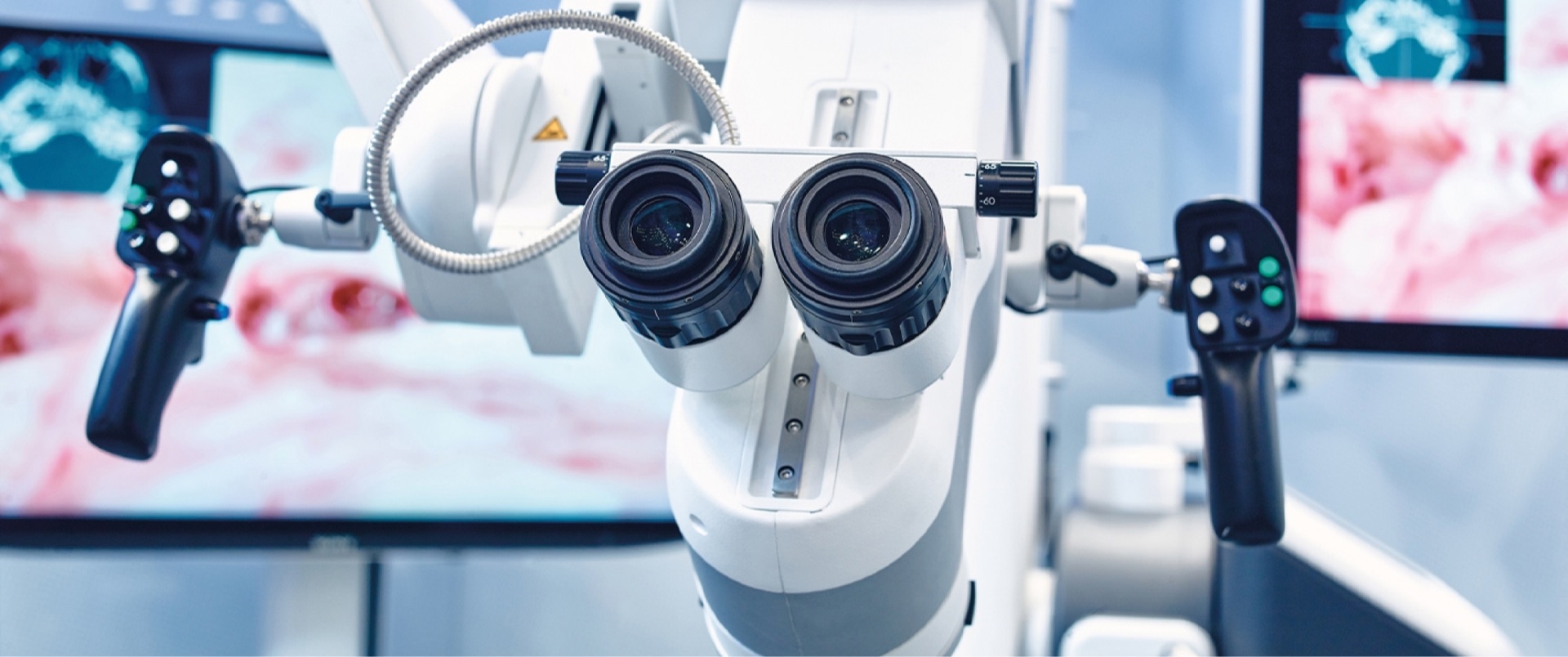 Digitales Operationsmikroskop von Munich Surgical Imaging mit Steuergriffen und Live-Bildschirmen im OP